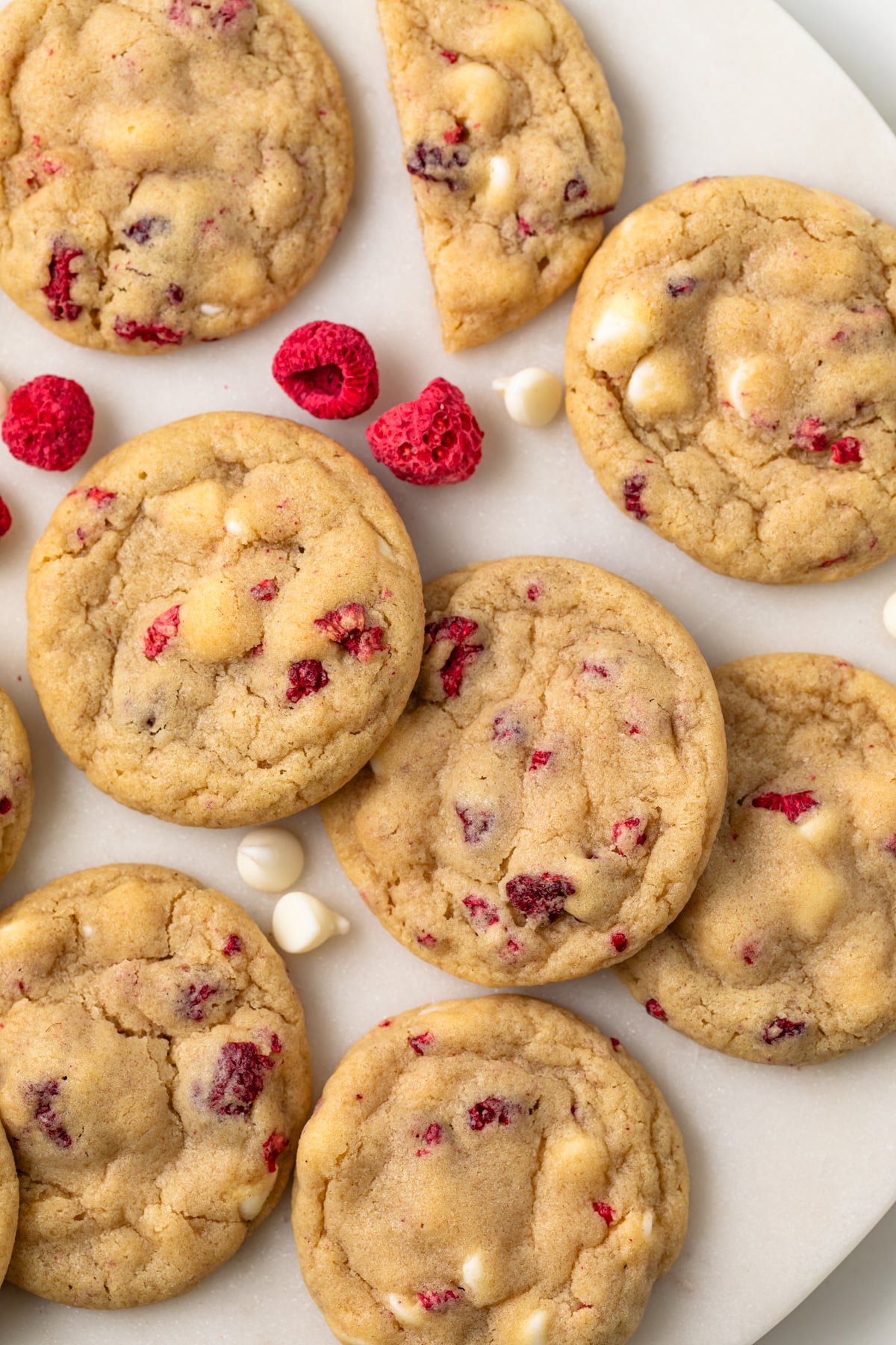Overhead of white chocolate raspberry cookies on parchment paper.