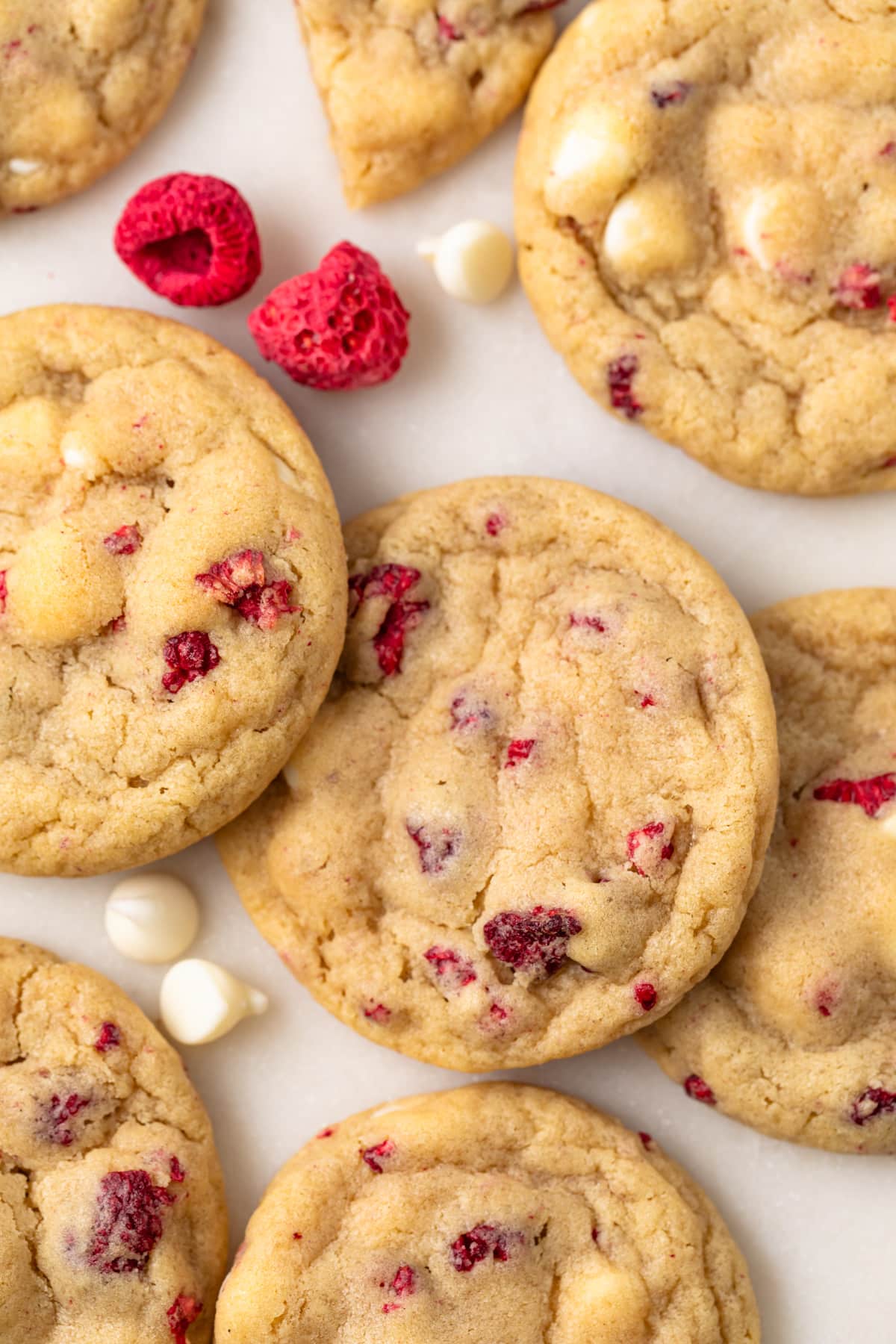 Close up of white chocolate raspberry cookies on parchment paper.