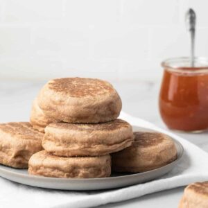 side view of whole wheat English Muffins on grey plate