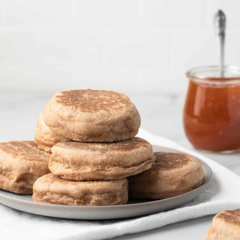 side view of whole wheat English Muffins on grey plate