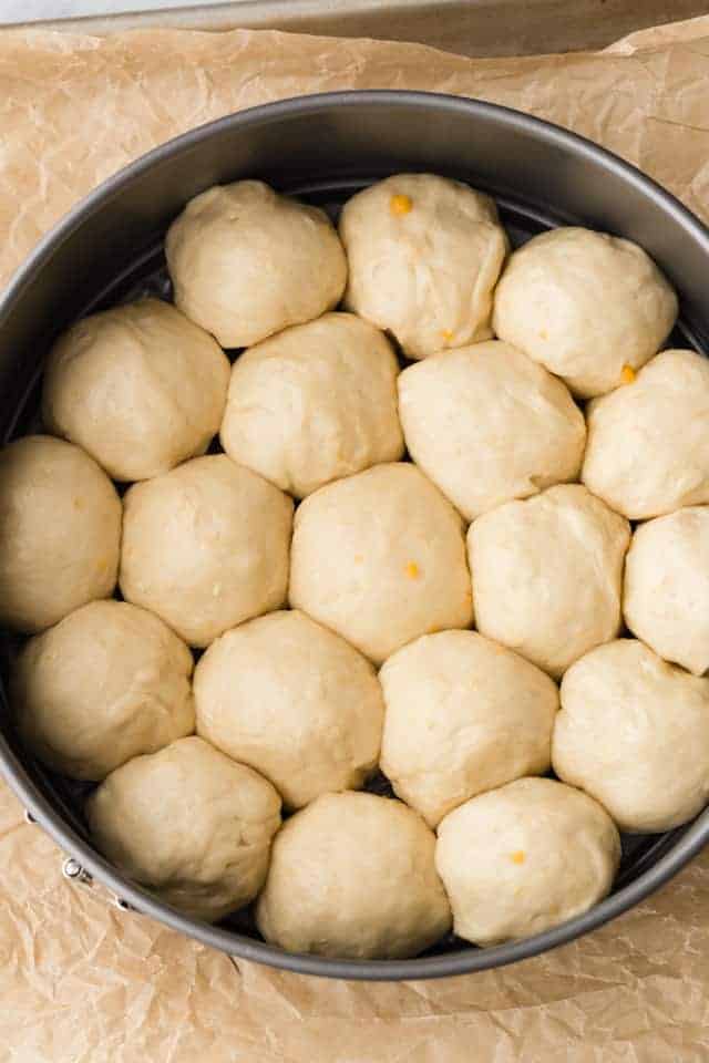 yeast dough balls in round pan