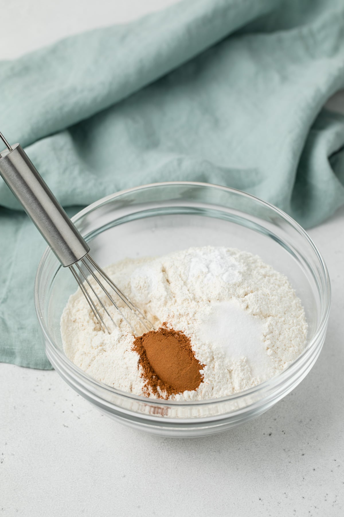 dry ingredients for zucchini bread in glass bowl with whisk